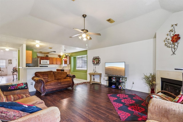 17006 Dusty Mill Dr E, Sugar Land, TX 77498 - living area featuring vaulted ceiling, ceiling fan, wood finished floors, and a fireplace
