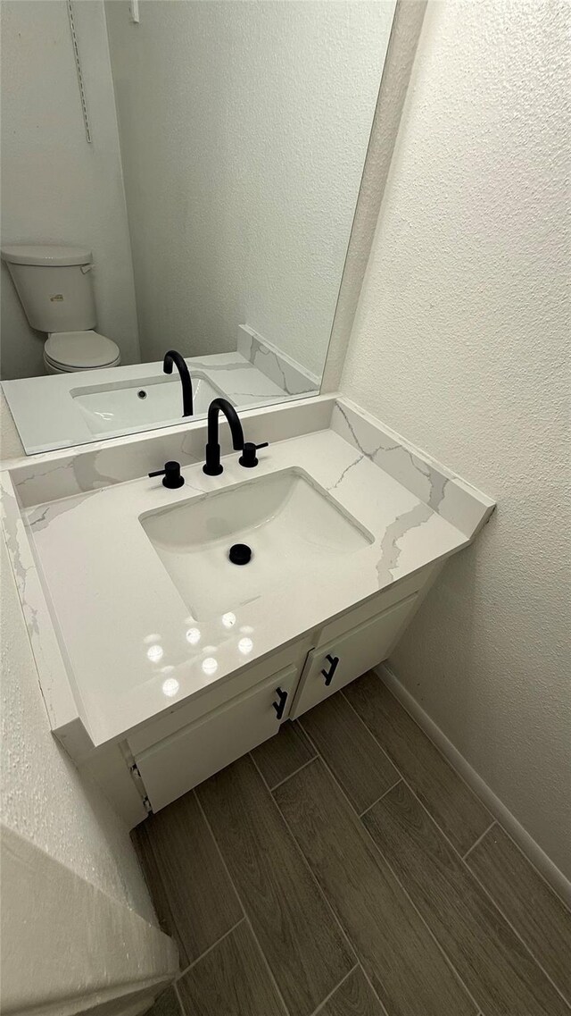 12922 Wirevine Ln, Houston, TX 77072 - half bathroom with vanity and wood tiled floors