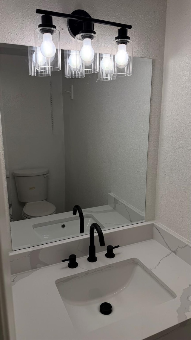 12922 Wirevine Ln, Houston, TX 77072 - bathroom featuring a textured wall and vanity