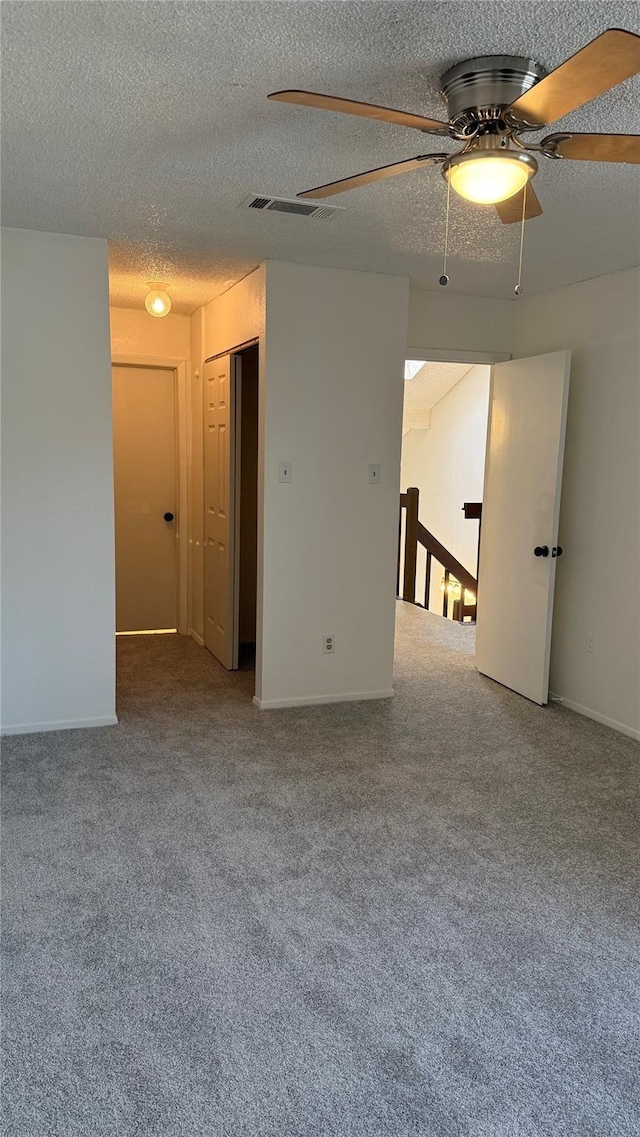 12922 Wirevine Ln, Houston, TX 77072 - empty room with carpet, ceiling fan, and a textured ceiling