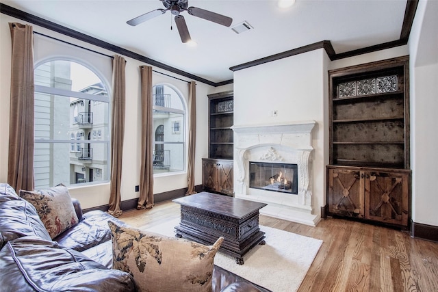 1241 W 24th St Unit C, Houston, TX 77008 - living room with ornamental molding, a fireplace, wood finished floors, and ceiling fan