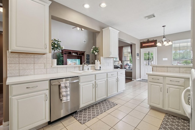 12103 Via San Rocco Ct, Cypress, TX 77429 - kitchen with stainless steel dishwasher, decorative backsplash, light countertops, white cabinetry, and a chandelier