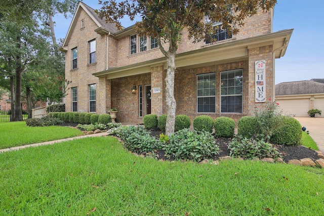 12103 Via San Rocco Ct, Cypress, TX 77429 - view of front of house featuring a front lawn, a garage, brick siding, and a porch
