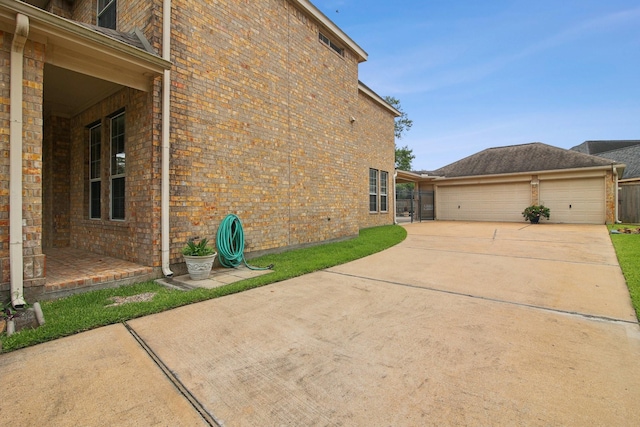 12103 Via San Rocco Ct, Cypress, TX 77429 - view of side of home with brick siding and concrete driveway
