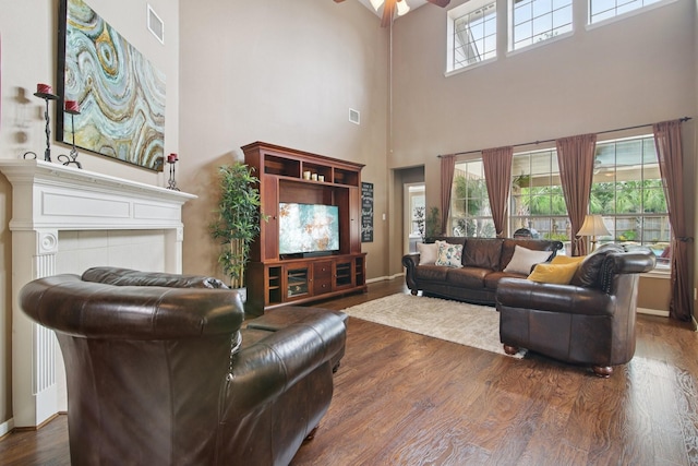 12103 Via San Rocco Ct, Cypress, TX 77429 - living area featuring a high ceiling, ceiling fan, wood finished floors, and a fireplace