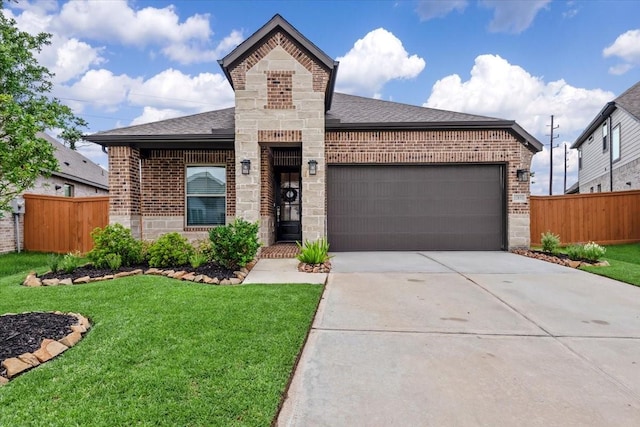 12831 Raemoir Dr, Humble, TX 77346 - french country home with brick siding, a garage, driveway, and roof with shingles