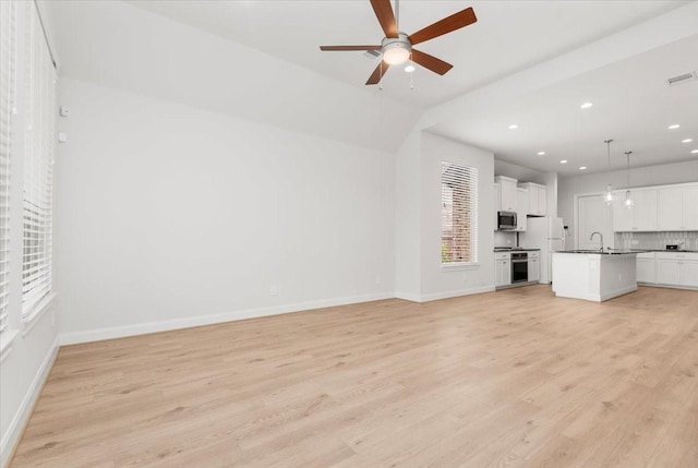 12831 Raemoir Dr, Humble, TX 77346 - unfurnished living room featuring ceiling fan, light wood finished floors, and recessed lighting
