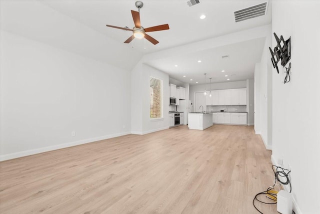 12831 Raemoir Dr, Humble, TX 77346 - unfurnished living room with light wood finished floors, recessed lighting, and a ceiling fan