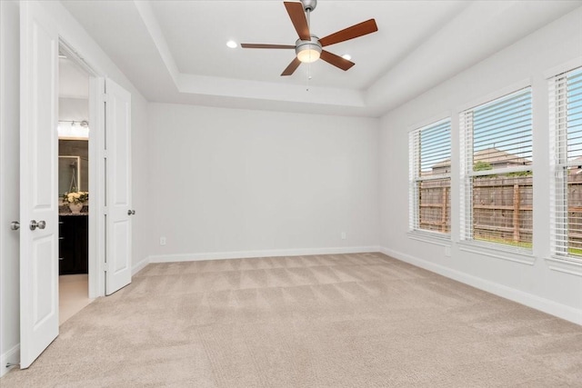 12831 Raemoir Dr, Humble, TX 77346 - unfurnished bedroom with light carpet, a tray ceiling, recessed lighting, and ceiling fan