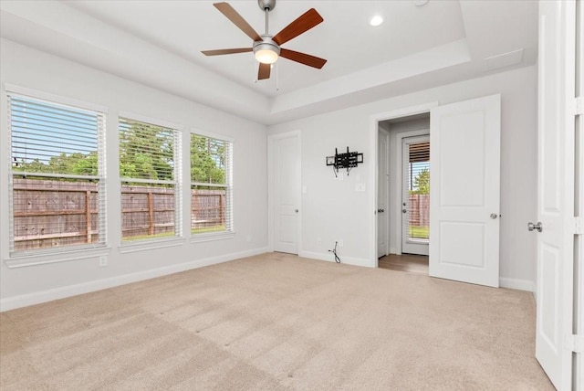 12831 Raemoir Dr, Humble, TX 77346 - spare room featuring light carpet, plenty of natural light, ceiling fan, a tray ceiling, and recessed lighting