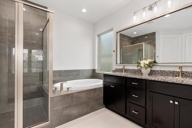 12831 Raemoir Dr, Humble, TX 77346 - full bathroom featuring double vanity, a shower stall, a bath, tile patterned flooring, and recessed lighting