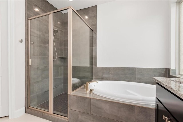 12831 Raemoir Dr, Humble, TX 77346 - full bathroom with a garden tub, vanity, and a stall shower