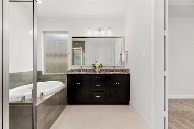 12831 Raemoir Dr, Humble, TX 77346 - bathroom with double vanity, a bath, and a shower stall
