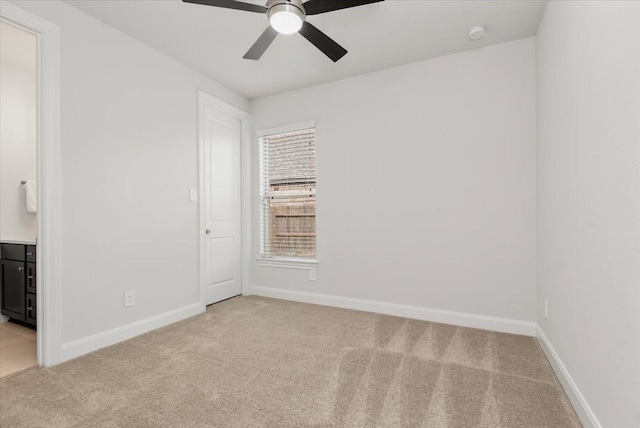12831 Raemoir Dr, Humble, TX 77346 - unfurnished bedroom with light colored carpet, connected bathroom, and a ceiling fan