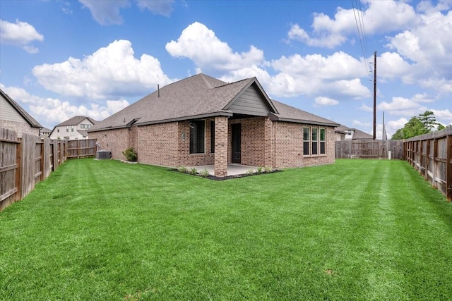 12831 Raemoir Dr, Humble, TX 77346 - rear view of house with brick siding, a fenced backyard, and a shingled roof