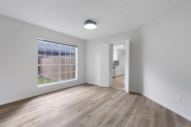 1815 Moston Dr, Spring, TX 77386 - empty room featuring wood finished floors and healthy amount of natural light