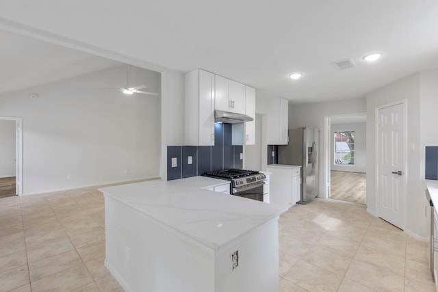 1815 Moston Dr, Spring, TX 77386 - kitchen featuring under cabinet range hood, appliances with stainless steel finishes, ceiling fan, light tile patterned flooring, and white cabinets