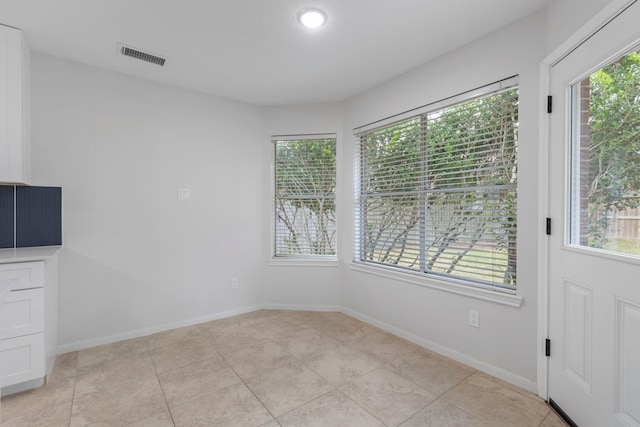 1815 Moston Dr, Spring, TX 77386 - unfurnished dining area with light tile patterned flooring and baseboards