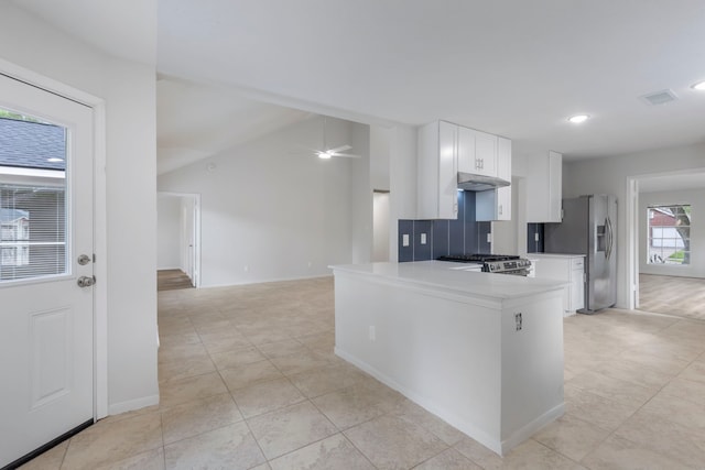 1815 Moston Dr, Spring, TX 77386 - kitchen with stainless steel appliances, light countertops, under cabinet range hood, white cabinets, and a ceiling fan