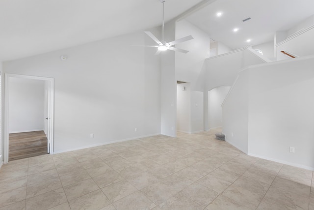 1815 Moston Dr, Spring, TX 77386 - unfurnished living room featuring arched walkways, ceiling fan, high vaulted ceiling, stairs, and tile patterned flooring