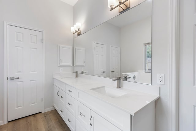 1815 Moston Dr, Spring, TX 77386 - bathroom with double vanity, wood finished floors, and a chandelier