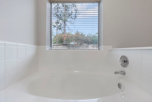 1815 Moston Dr, Spring, TX 77386 - full bathroom featuring a garden tub and healthy amount of natural light