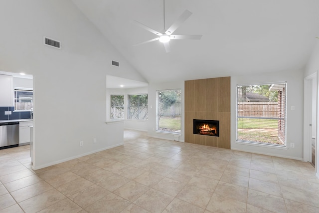 1815 Moston Dr, Spring, TX 77386 - unfurnished living room with plenty of natural light, high vaulted ceiling, ceiling fan, light tile patterned flooring, and a fireplace