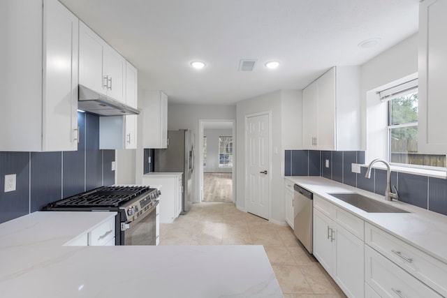 1815 Moston Dr, Spring, TX 77386 - kitchen featuring under cabinet range hood, appliances with stainless steel finishes, white cabinetry, and recessed lighting