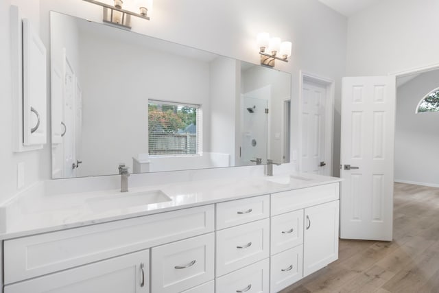 1815 Moston Dr, Spring, TX 77386 - bathroom with double vanity, a shower with door, and wood finished floors
