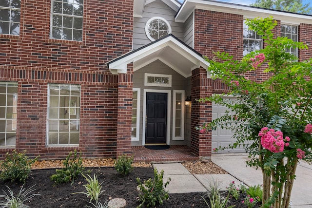 1815 Moston Dr, Spring, TX 77386 - view of exterior entry featuring a garage and brick siding