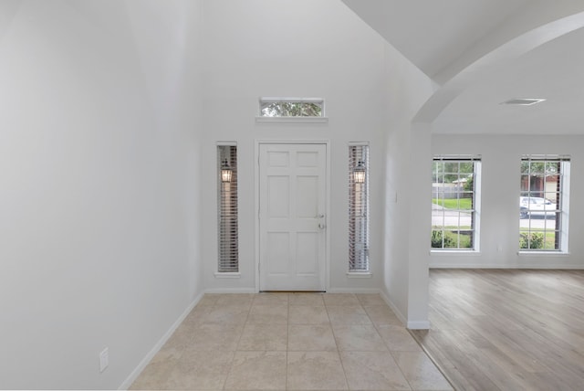 1815 Moston Dr, Spring, TX 77386 - foyer entrance with arched walkways and a high ceiling