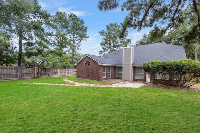 1815 Moston Dr, Spring, TX 77386 - rear view of property with brick siding, a patio area, and roof with shingles