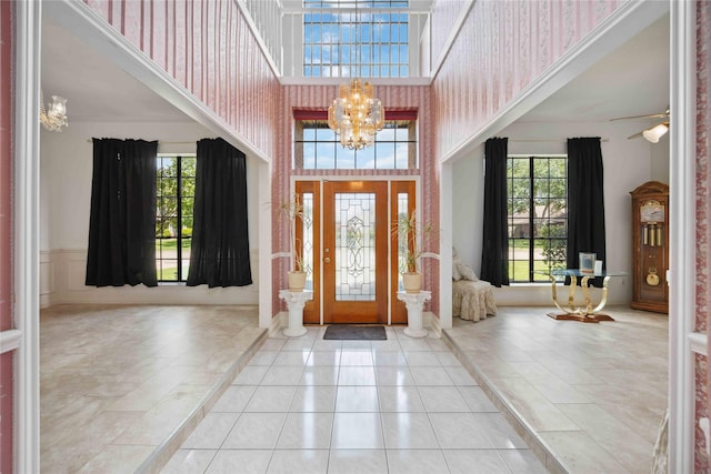 2701 11th St N, Texas City, TX 77590 - tiled foyer entrance with a high ceiling, a chandelier, and a ceiling fan