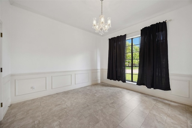 2701 11th St N, Texas City, TX 77590 - spare room with a chandelier, a wainscoted wall, and a decorative wall