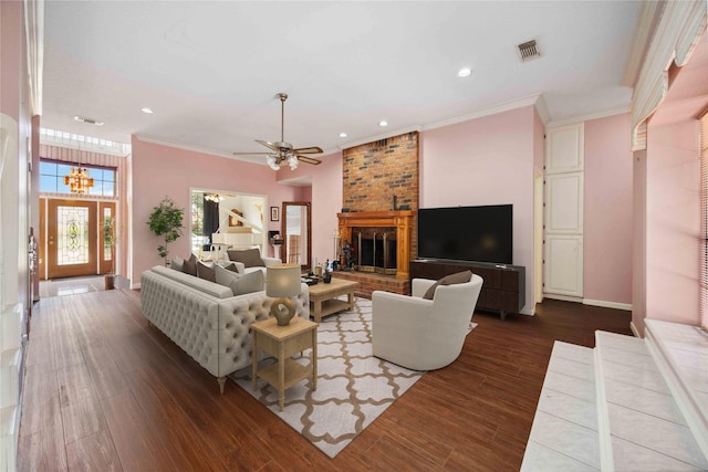 2701 11th St N, Texas City, TX 77590 - living room with dark wood-style floors, a ceiling fan, a fireplace, crown molding, and recessed lighting