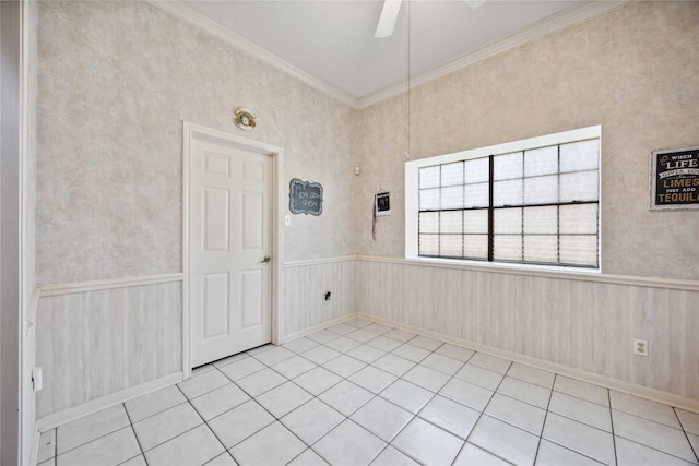 2701 11th St N, Texas City, TX 77590 - spare room featuring ornamental molding, a ceiling fan, wainscoting, and light tile patterned floors
