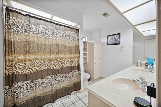 2701 11th St N, Texas City, TX 77590 - full bathroom with tile patterned floors, double vanity, and a shower with curtain