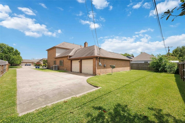 2701 11th St N, Texas City, TX 77590 - rear view of property with brick siding, a garage, concrete driveway, and a chimney