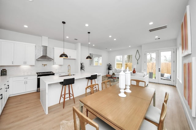 4415 Coke St Unit B, Houston, TX 77020 - dining room with light wood-type flooring, recessed lighting, and french doors