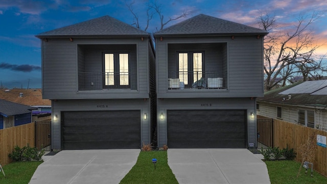 4415 Coke St Unit B, Houston, TX 77020 - view of front of home with a garage, a balcony, concrete driveway, and a shingled roof