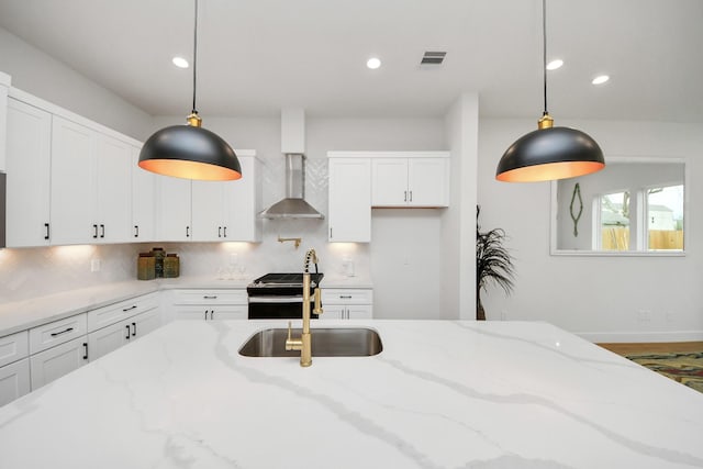 4415 Coke St Unit B, Houston, TX 77020 - kitchen with wall chimney range hood, electric range, tasteful backsplash, white cabinets, and recessed lighting