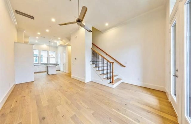 4041 Leeland St, Houston, TX 77023 - unfurnished living room with ceiling fan, light wood-style flooring, stairs, recessed lighting, and ornamental molding