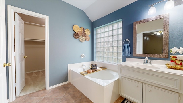 18118 Castle Rain Dr, Humble, TX 77346 - bathroom with a garden tub, vanity, a walk in closet, lofted ceiling, and tile patterned flooring