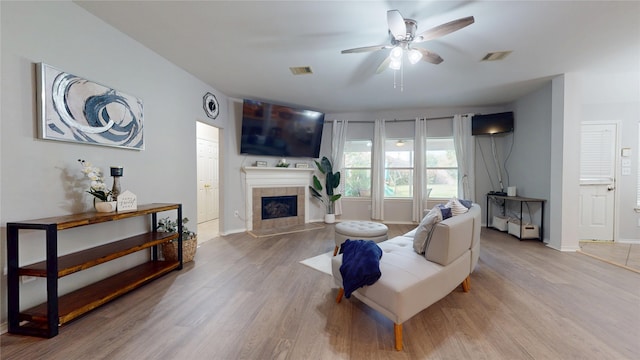 18118 Castle Rain Dr, Humble, TX 77346 - living room featuring ceiling fan, wood finished floors, and a tile fireplace