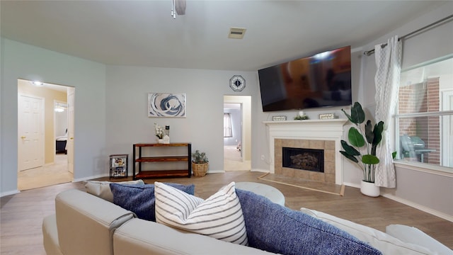 18118 Castle Rain Dr, Humble, TX 77346 - living room featuring wood finished floors and a tiled fireplace