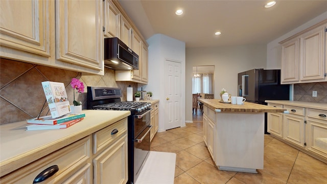 18118 Castle Rain Dr, Humble, TX 77346 - kitchen featuring stainless steel appliances, butcher block countertops, cream cabinets, tasteful backsplash, and recessed lighting