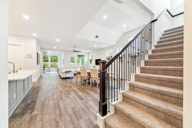 16630 Polletts Cove Ct, Humble, TX 77346 - stairway featuring wood finished floors, ceiling fan, and recessed lighting