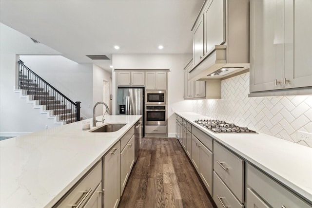 16630 Polletts Cove Ct, Humble, TX 77346 - kitchen with stainless steel appliances, gray cabinetry, dark wood-style flooring, decorative backsplash, and recessed lighting