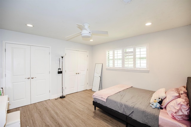 6203 Wickwillow Ln, Alvin, TX 77511 - bedroom with light wood-style flooring, multiple closets, recessed lighting, and ceiling fan