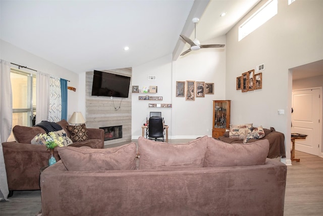 6203 Wickwillow Ln, Alvin, TX 77511 - living room with a large fireplace, wood finished floors, plenty of natural light, a ceiling fan, and high vaulted ceiling